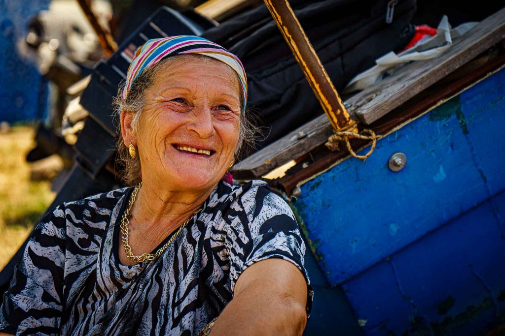 Portrait of an elderly woman selling herbs and handmade goods at a local market in Kardzhali, Bulgaria.